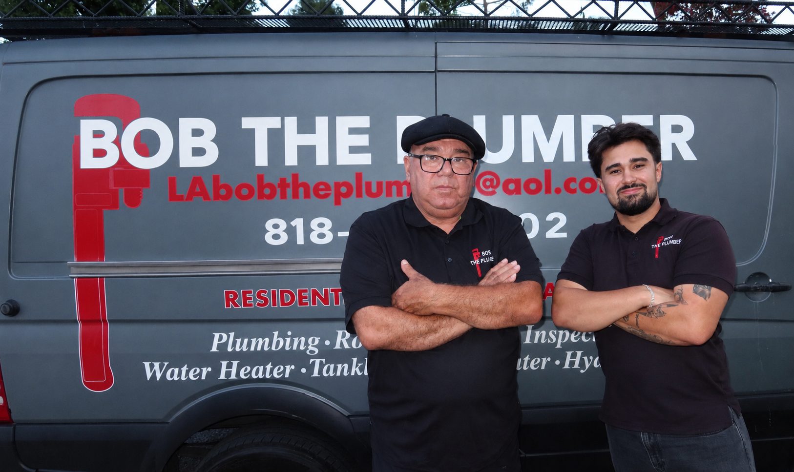 Bob and Jeremy, owners of Bob The Plumber, in front of their service truck